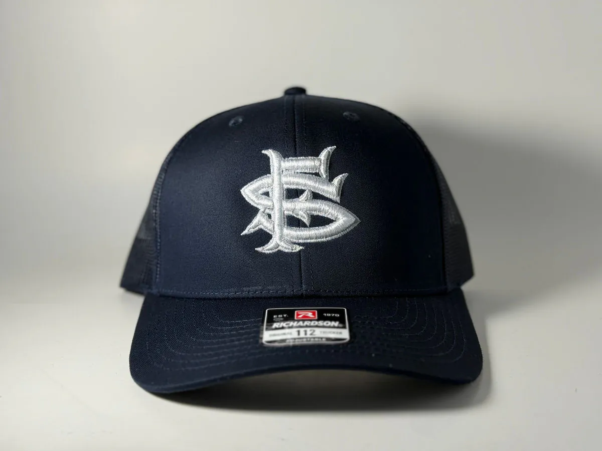 Navy trucker cap embroidered with a white San Francisco shark monogram