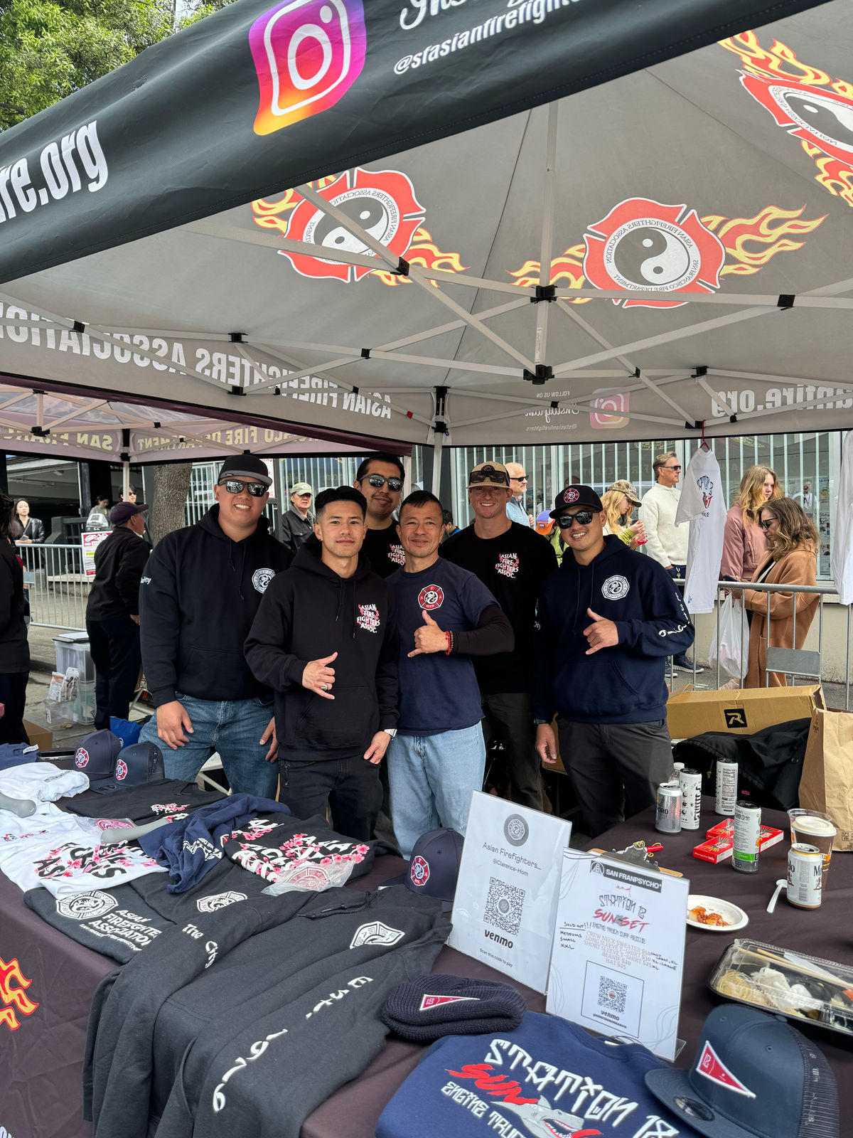 The store's booth at a community event, table laid out with department apparel