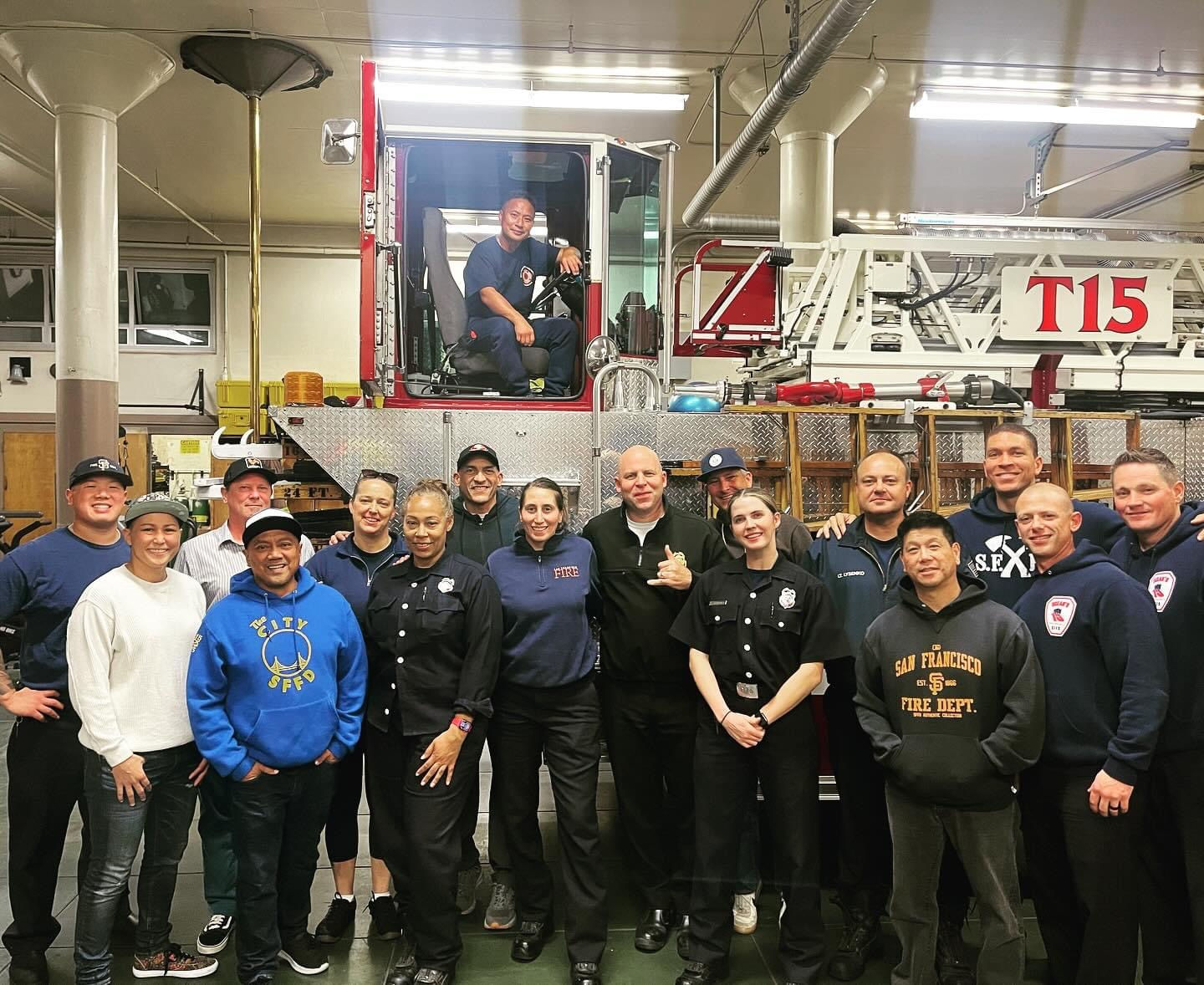 Members gathered in the apparatus bay in front of Truck 15