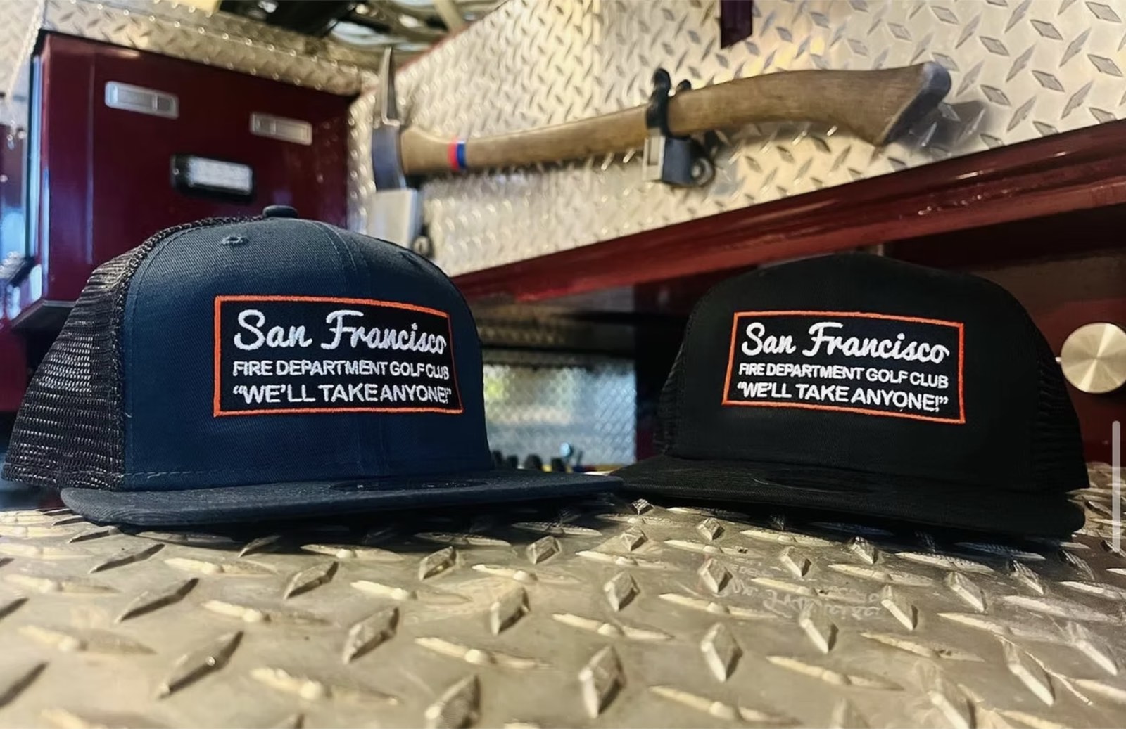 San Francisco Fire Department "We'll take anyone" caps on a diamond-plate counter
